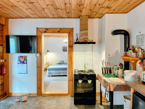 Salon z kuchnią i smart tv z pełnym pakietem Netflix. - Karolówka Nad Osławą apartament na wyłączność z dużym ogrodem nad rzeką.