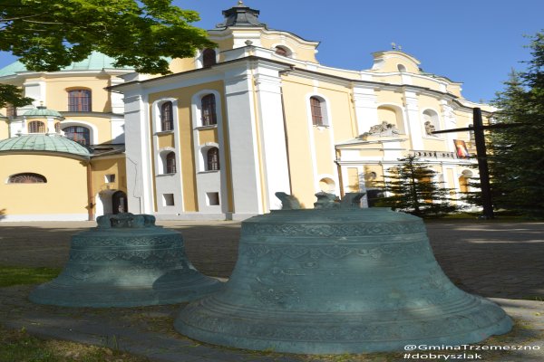 Historyczne dzwony na tle bazyliki - Bazylika pw. Wniebowzięcia NMP w Trzemesznie